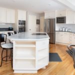 The kitchen island features built in shelving