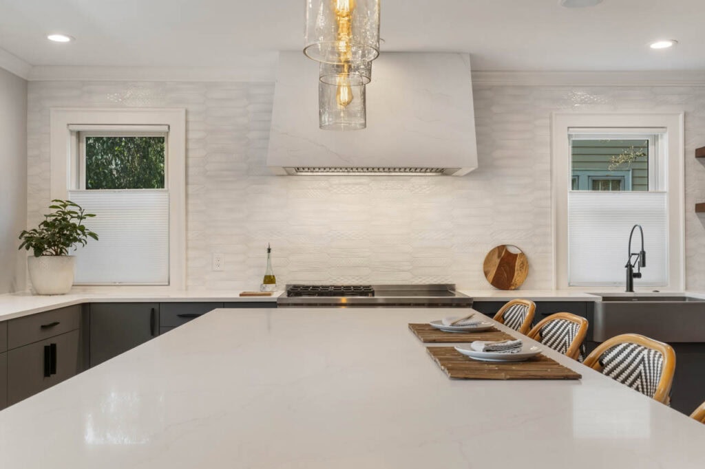 The quartz range hood was a custom design fabricated from the same material as the countertop.