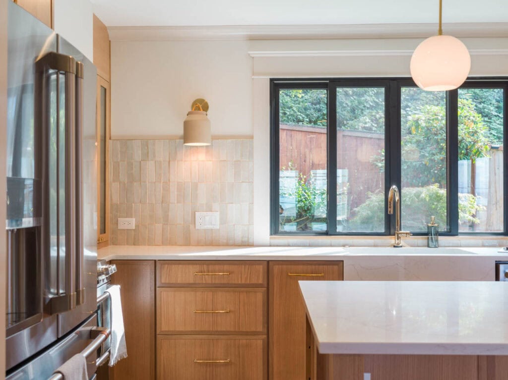 Seattle kitchen remodel by J & M Remodel Seattle, WA. View of the kitchen facing the sink. Picket tile backsplash layout. Large quartz island.